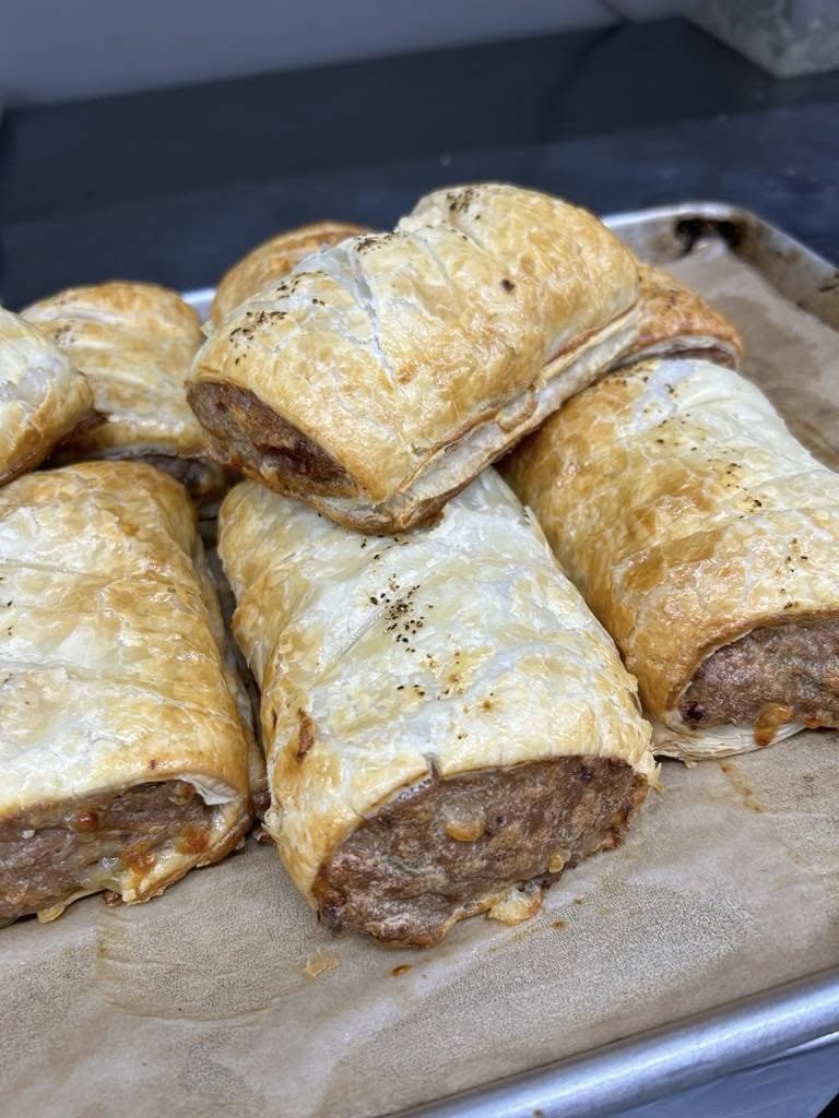 Freshly baked flaky sausage rolls straight from the oven